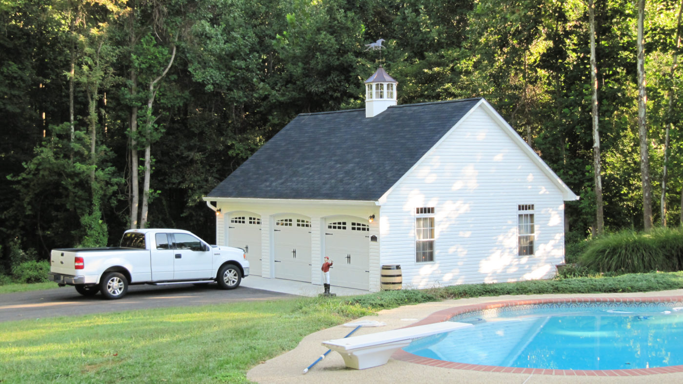 exterior photo of truck and pool by amish built garage for sale