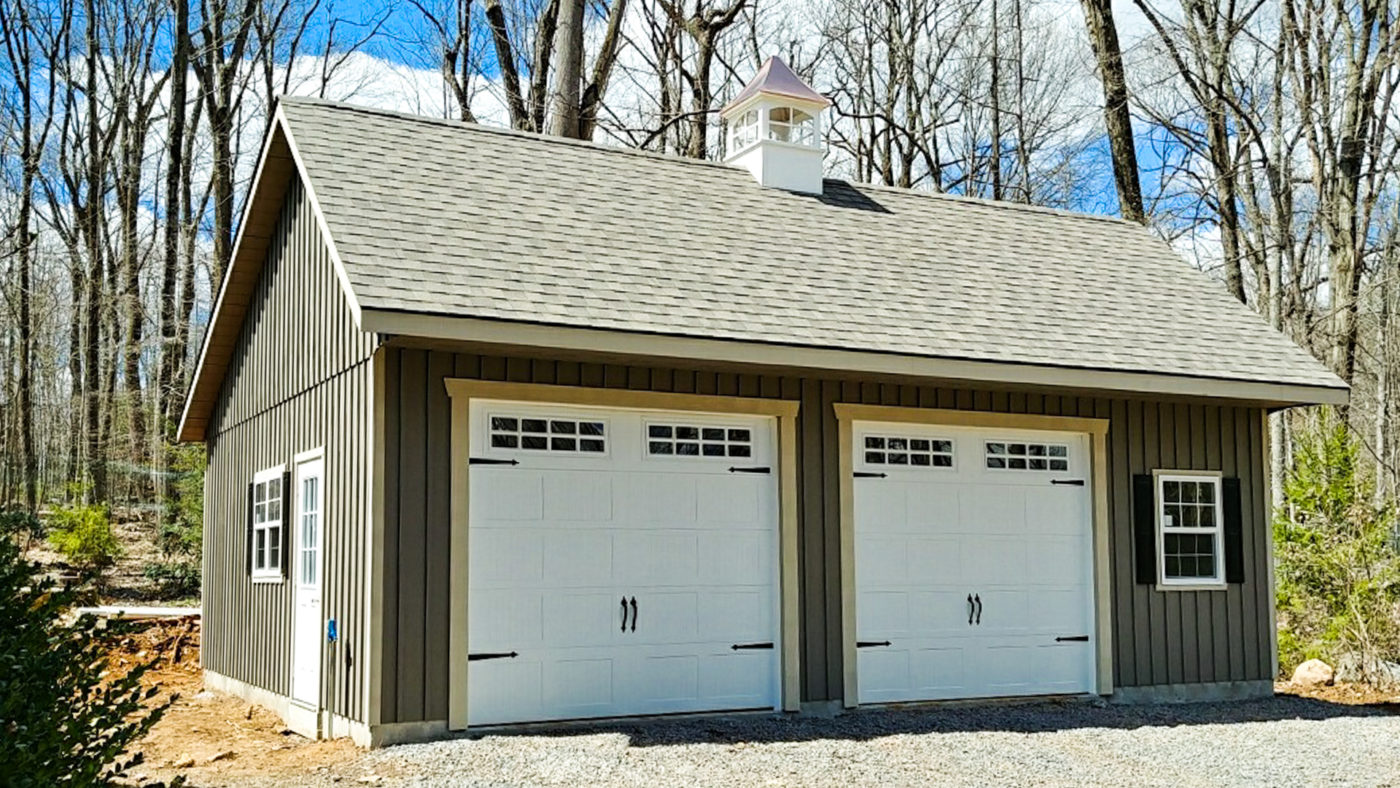 exterior of green and white board and batten detached garage