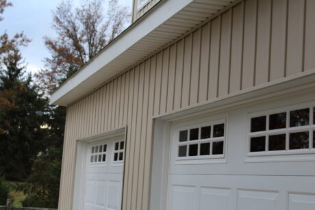 two story garage with vinyl board and batten