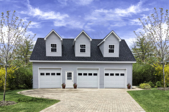 2-story 3-car garage with dormers and vinyl siding