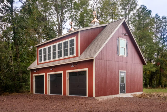 A 24x38 2-story 3-car garage with red wood siding in Pennsylvania