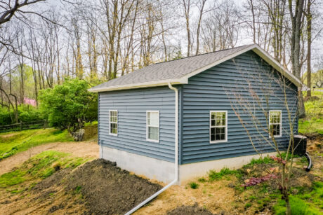 20x20 garage with blue vinyl siding and white trim in a forest in downingtown pa 2