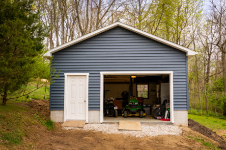 20x20 garage with blue vinyl siding and white trim in a forest in downingtown pa 2
