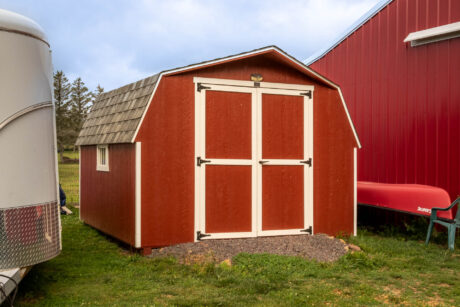 A red and white 10x10 mini barn.