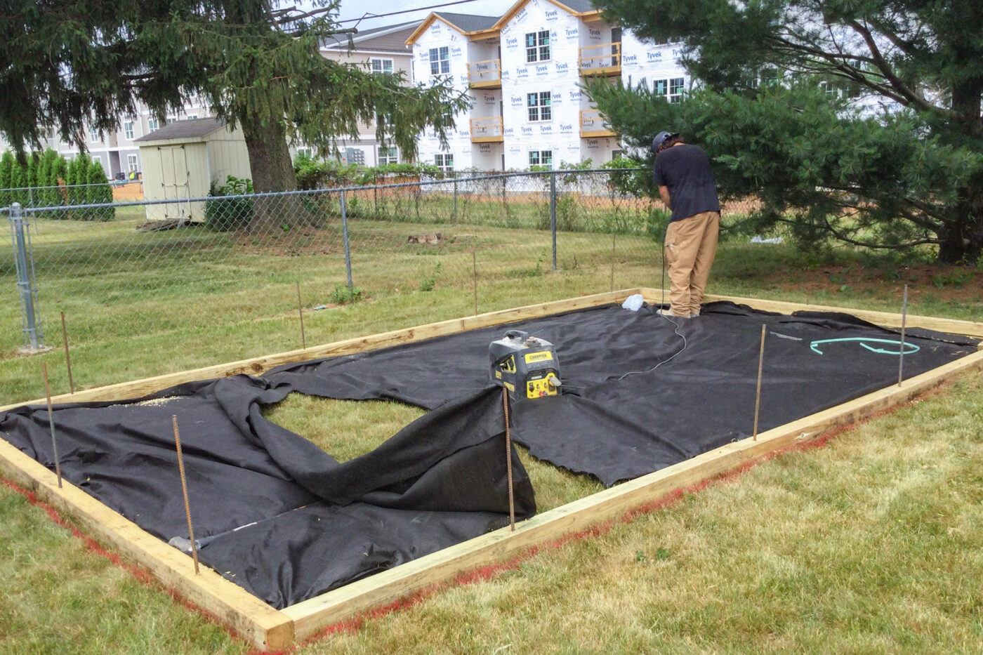 installing lining for gravel shed pad