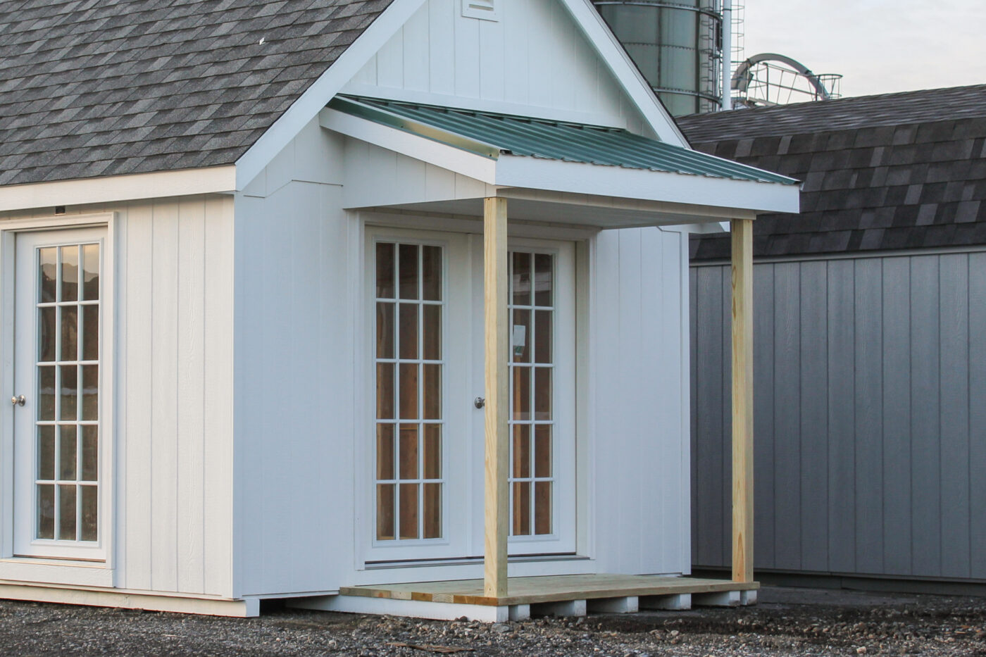 small porch overhang over the side entrance door to shed